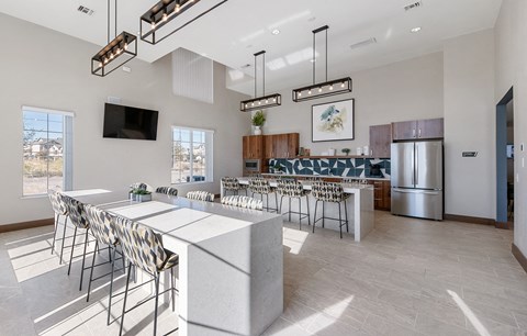 an open kitchen and dining room with a bar and chairs