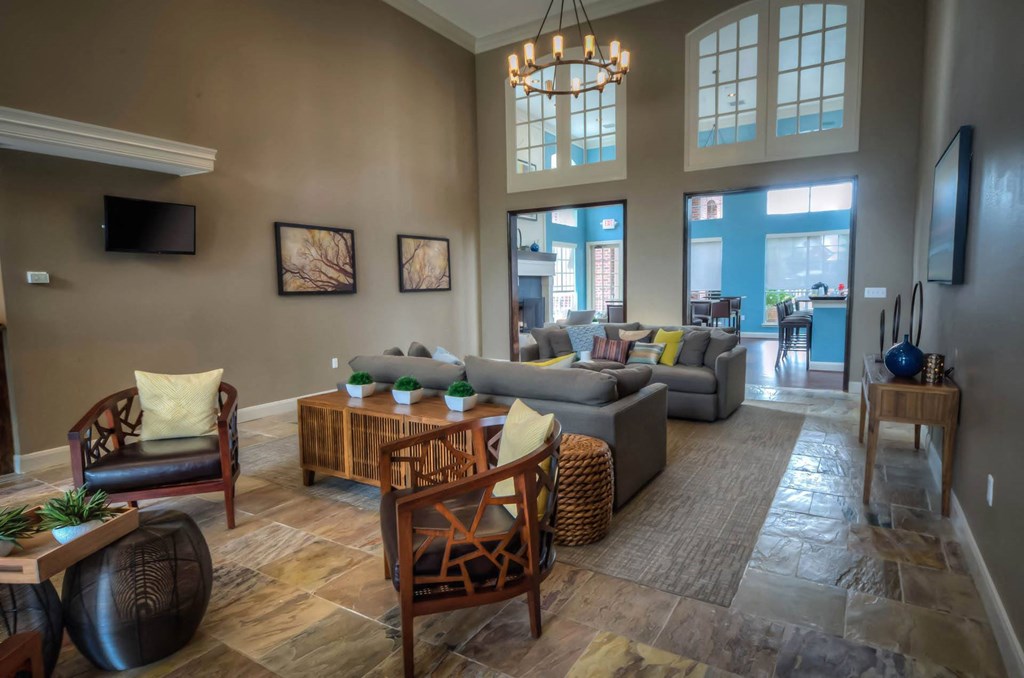 Community Room with gray couch at Villa Springs, Houston, TX