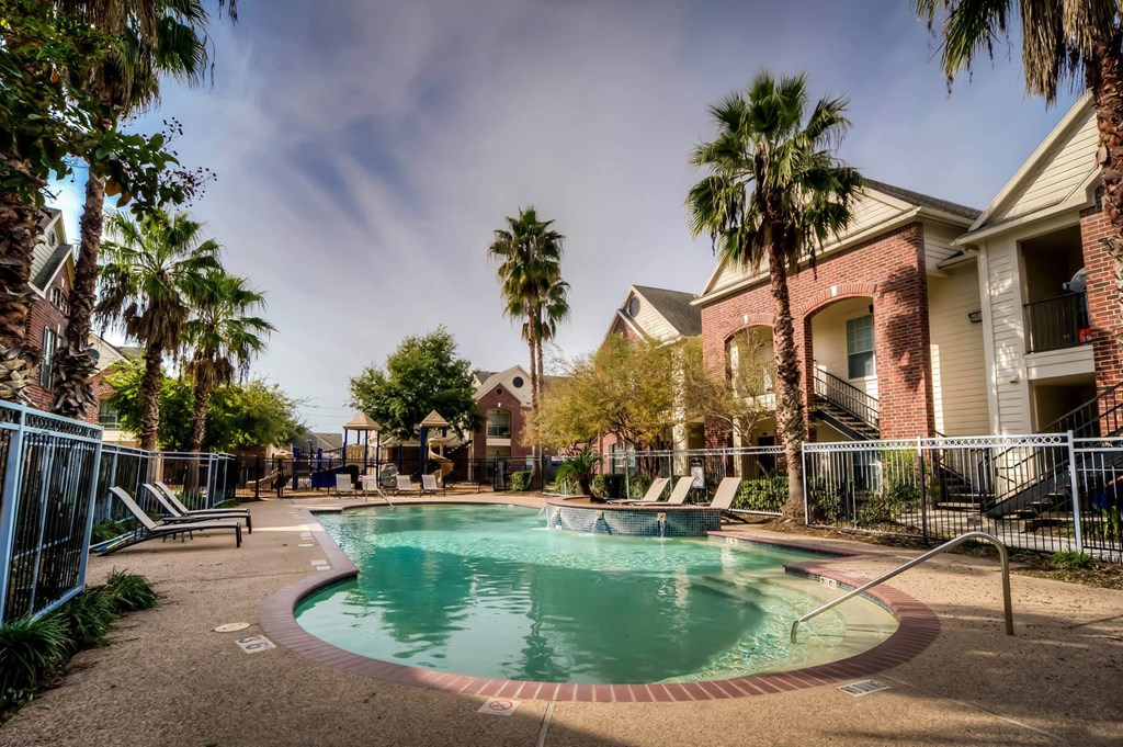 Pool with palm trees at Villa Springs, Houston, TX, 77090