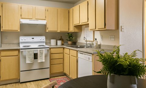 a kitchen with white appliances and wooden cabinets