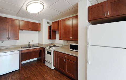 a kitchen with wooden cabinets and white appliances