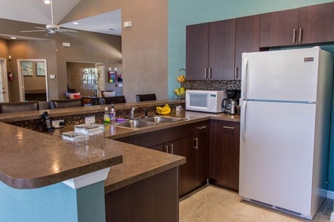 a kitchen with a counter top and a refrigerator