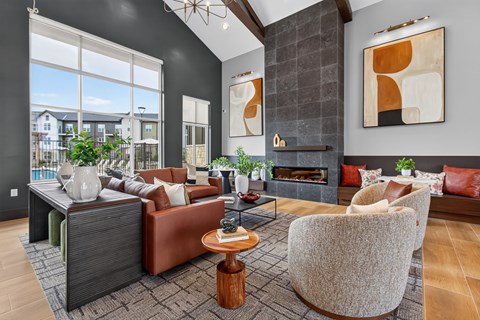 A modern living room with a fireplace and a large window.