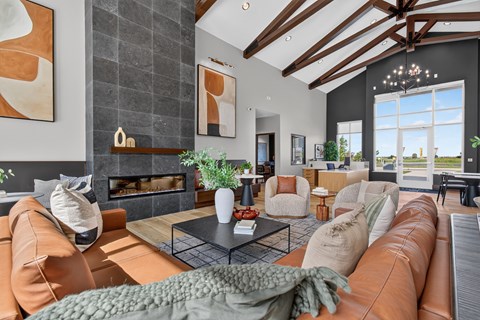 A living room with a fireplace and a large window.