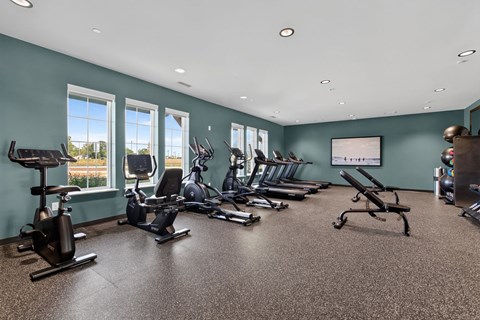 A spacious gym with a variety of exercise equipment.