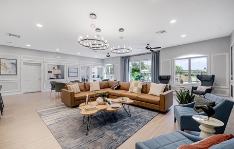 A spacious living room with a large sectional sofa and a coffee table in the center.