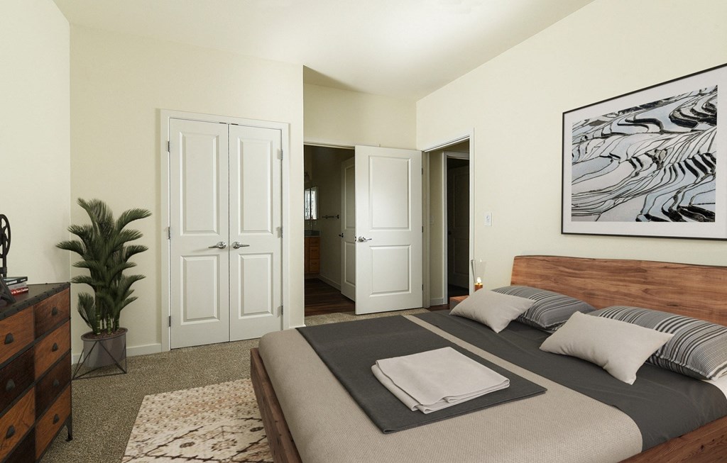 a bedroom with a bed and a painting on the wall a bedroom with a bed and a painting on the wall at Aviara Flats, Arizona
