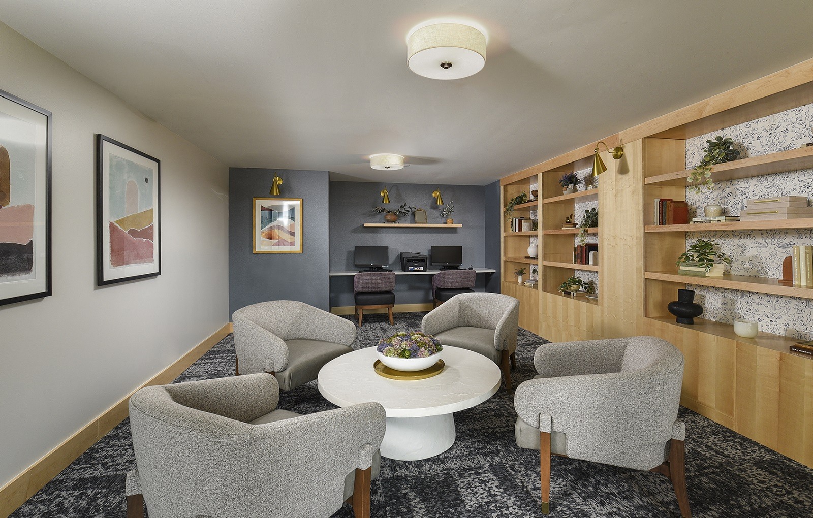 A living room with grey chairs and a white coffee table.
