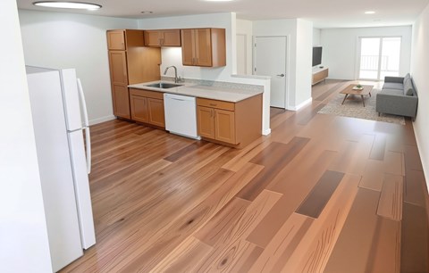 A kitchen with wooden floors and white appliances.