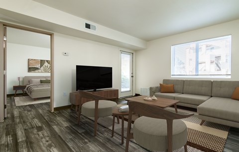 A living room with a grey couch and a wooden table.