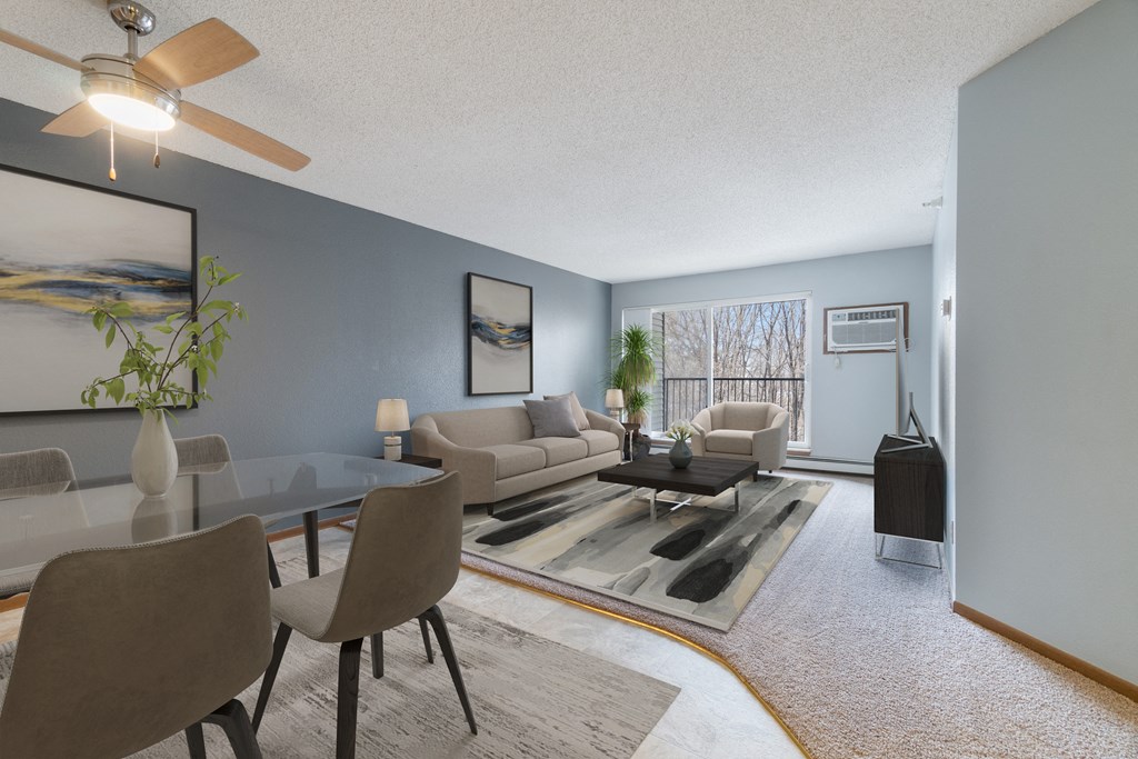 an open living room with couches and a table and chairs