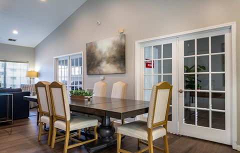 A dining room with a table and chairs.