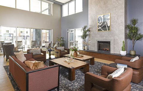 A living room with a fireplace and a painting on the wall.