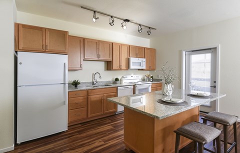 A kitchen with wooden cabinets and a white refrigerator.