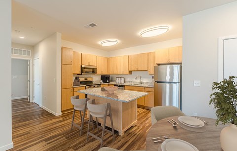 A kitchen with a table and chairs in the middle of the room.