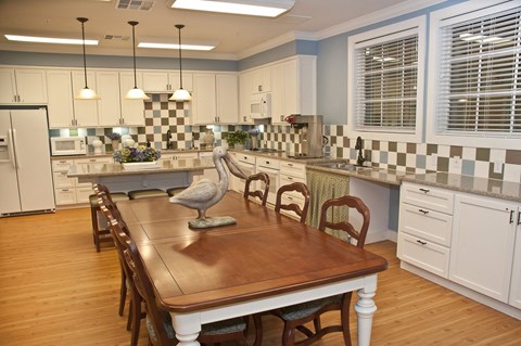 a kitchen with a wooden table and a counter top