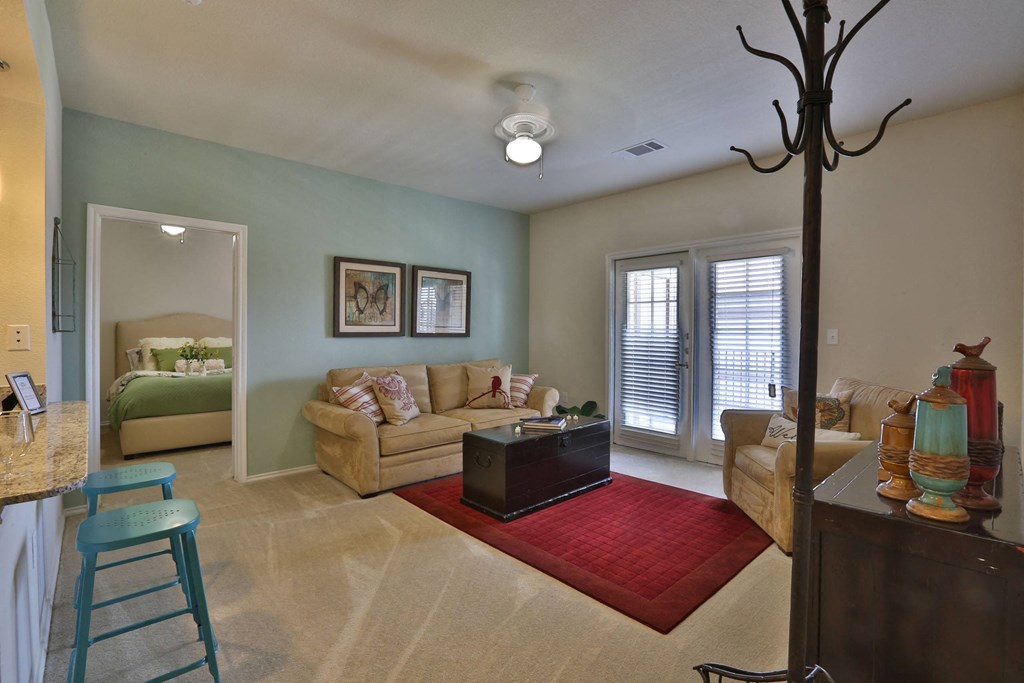 a living room with a couch and a table at Cedars of Elk Drive 55+ Apartments, Burleson, TX 76028