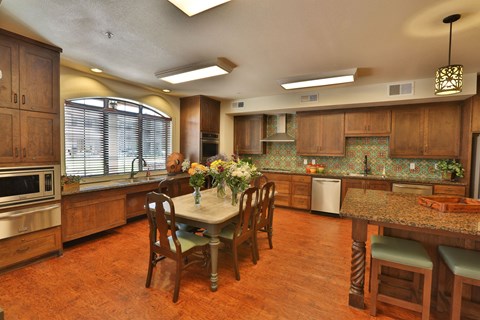 a large kitchen with a large island and a table with chairs