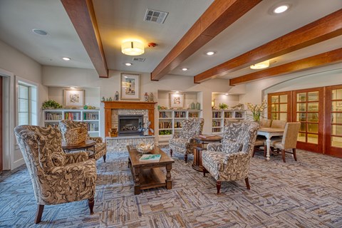 a living room with couches and chairs and a fireplace at Sylvia at South Broadway 55+ Apartments, Joshua Texas