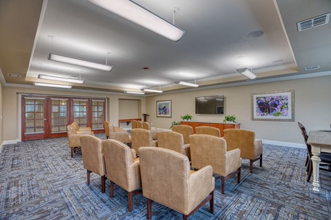 a conference room with chairs and a table at Sylvia at South Broadway 55+ Apartments, Joshua, TX