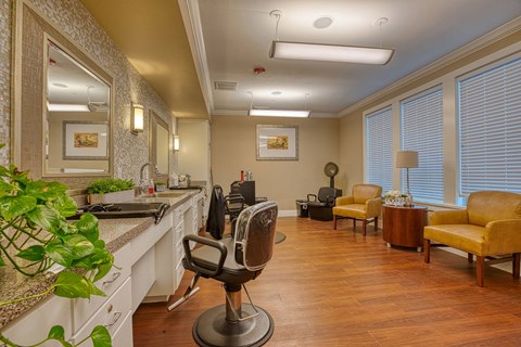a salon room with a counter with a chair and a mirror at Sylvia at South Broadway 55+ Apartments, Joshua Texas