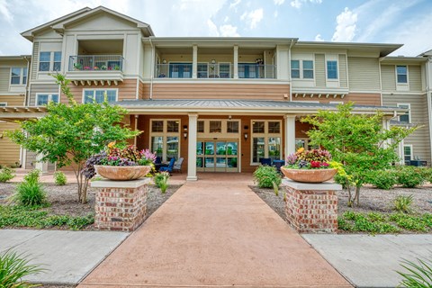walkway to the entrance of an apartment building at Sylvia at South Broadway 55+ Apartments, Joshua
