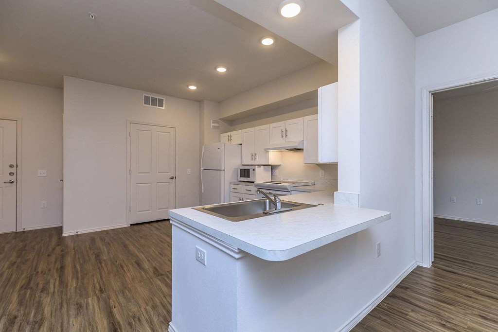 a kitchen with white cabinets and a sink at Mariposa at Westchester, TX 75052