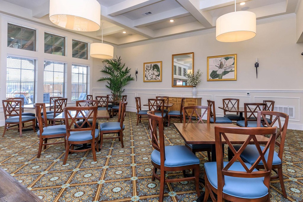 a dining room with wooden tables and chairs and windows at Mariposa at Westchester, TX 75052