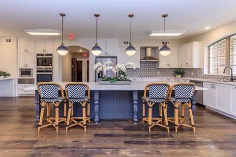 a large kitchen with a large island and chairs