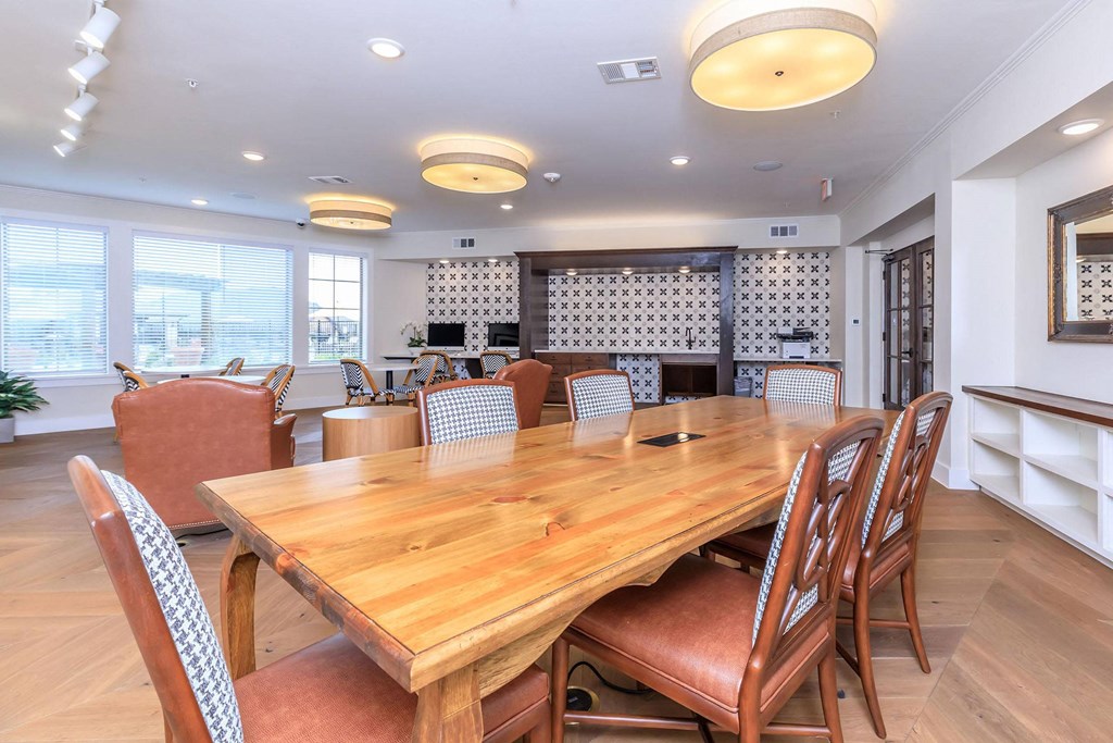 a dining room with a wooden table and chairs at Mariposa at Westchester, Grand Prairie, TX