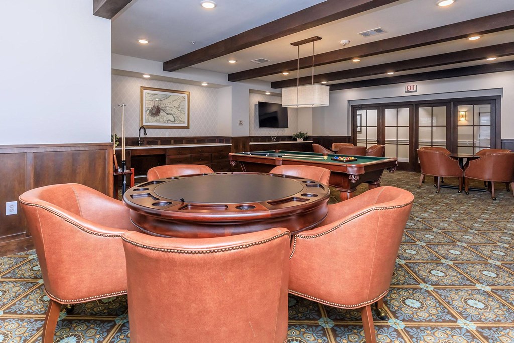 a game room with a pool table and chairs at Mariposa at Westchester, Grand Prairie, 75052