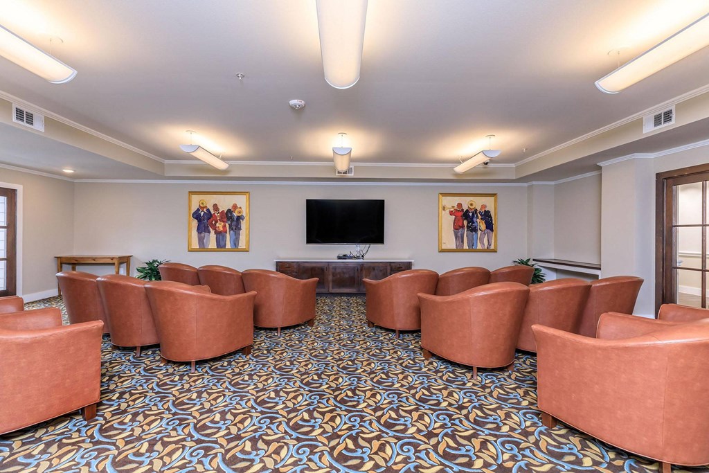 a conference room with couches and a table in front of a television at Mariposa at Westchester, Grand Prairie Texas