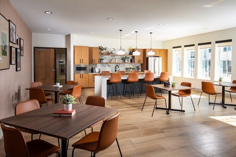 A modern dining room with a wooden table and chairs.