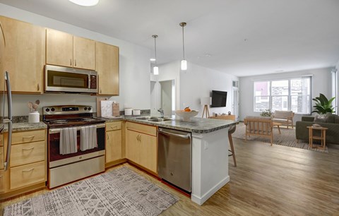 A kitchen with wooden cabinets and a white island.