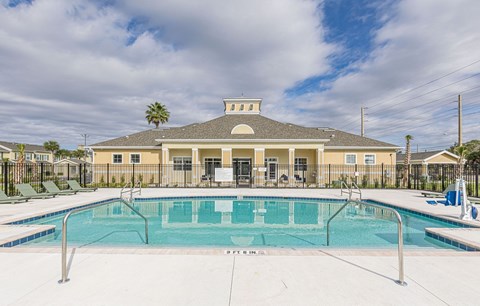 A large building with a pool in front of it.
