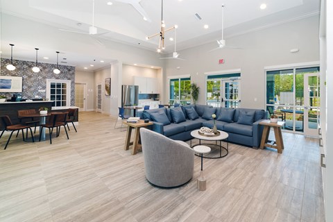 A spacious living room with a grey sofa and a round chair.