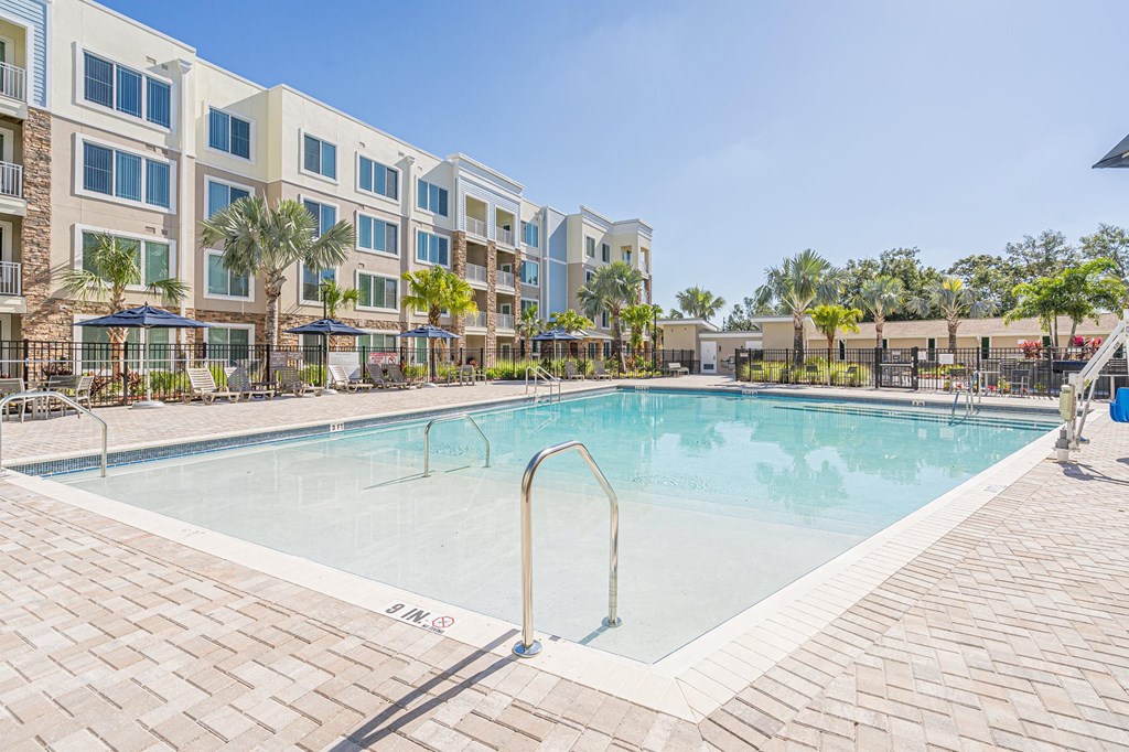 Swimming pool view with patio at Sandpiper Glen 62+ Apartments, Orlando, FL, 32825