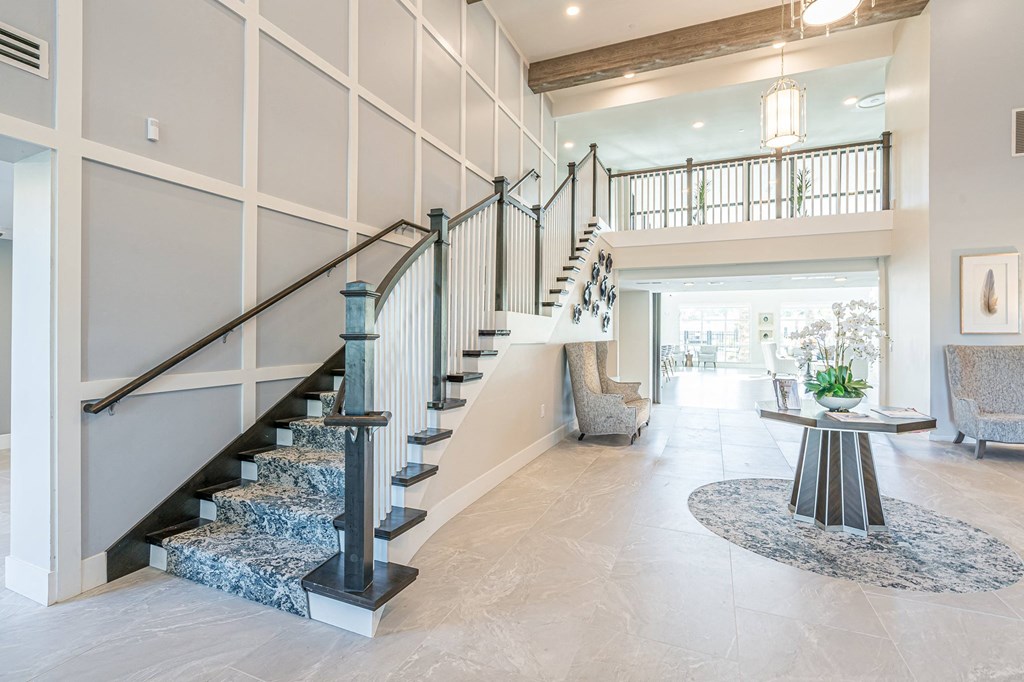 Living room and stairs at Sandpiper Glen 62+ Apartments, Orlando, Florida