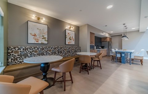 A modern dining room with a stone backsplash and wooden furniture.