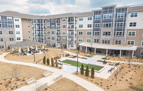 A large apartment complex with a courtyard and a pool.