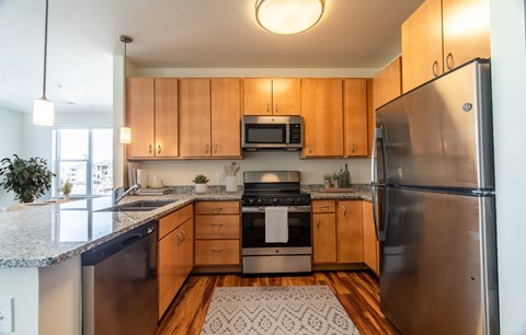 A kitchen with wooden cabinets and stainless steel appliances.