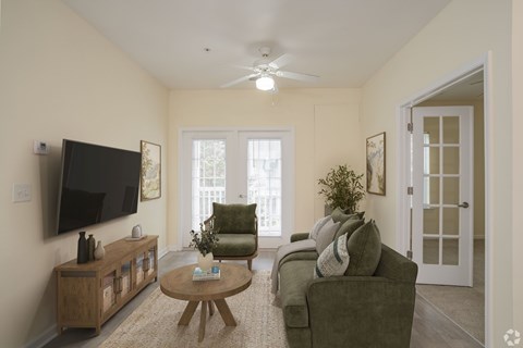 A living room with a green chair and a brown coffee table.