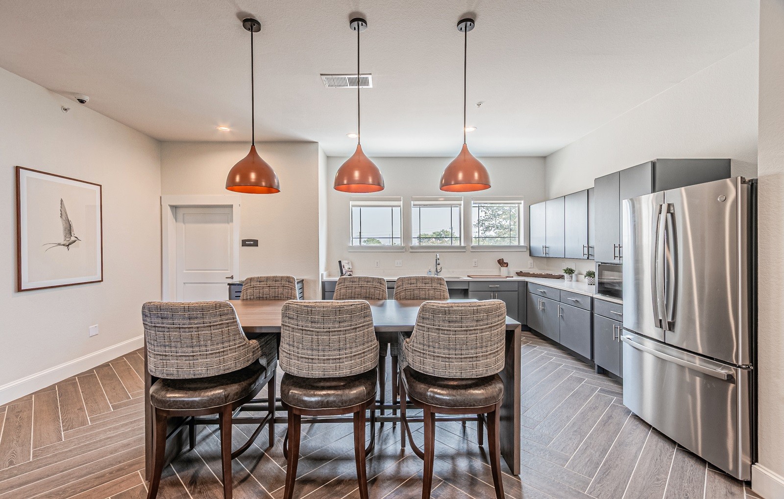 A kitchen with a table and chairs in the middle of it.