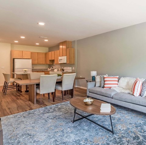 a living room and kitchen with a couch and a table