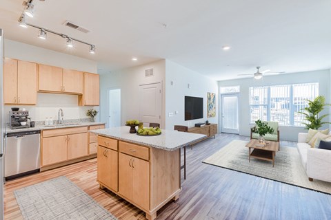 A modern kitchen with wooden cabinets and a central island.
