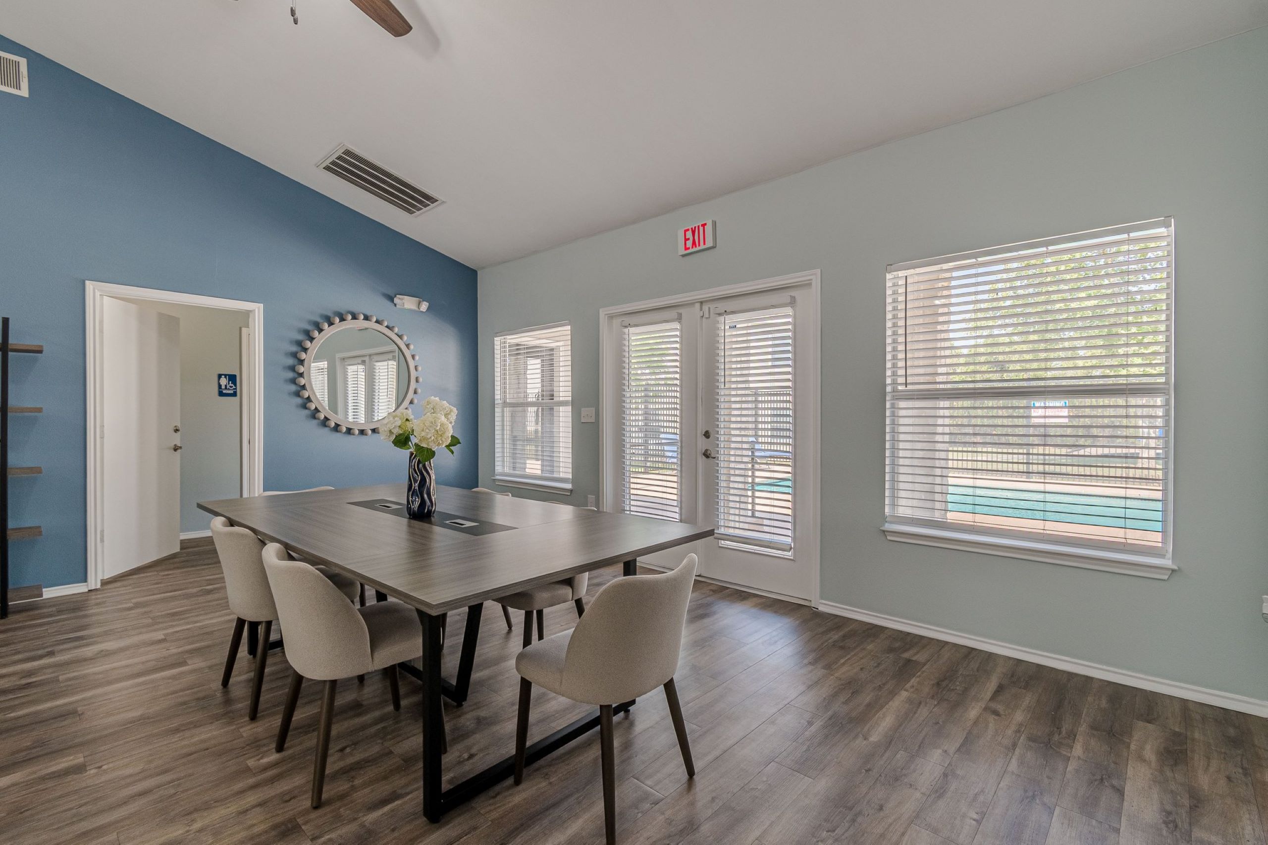 A dining room with a table and chairs.