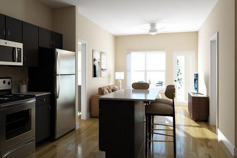 A modern kitchen with a black countertop and stainless steel appliances.