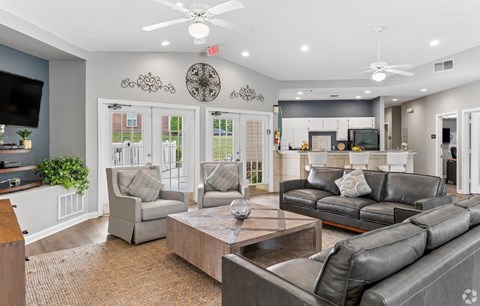 A living room with a grey couch and a wooden table.
