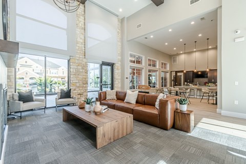 A living room with a grey carpet and a wooden coffee table.