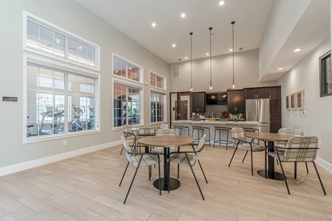 A modern dining room with a large table and chairs.